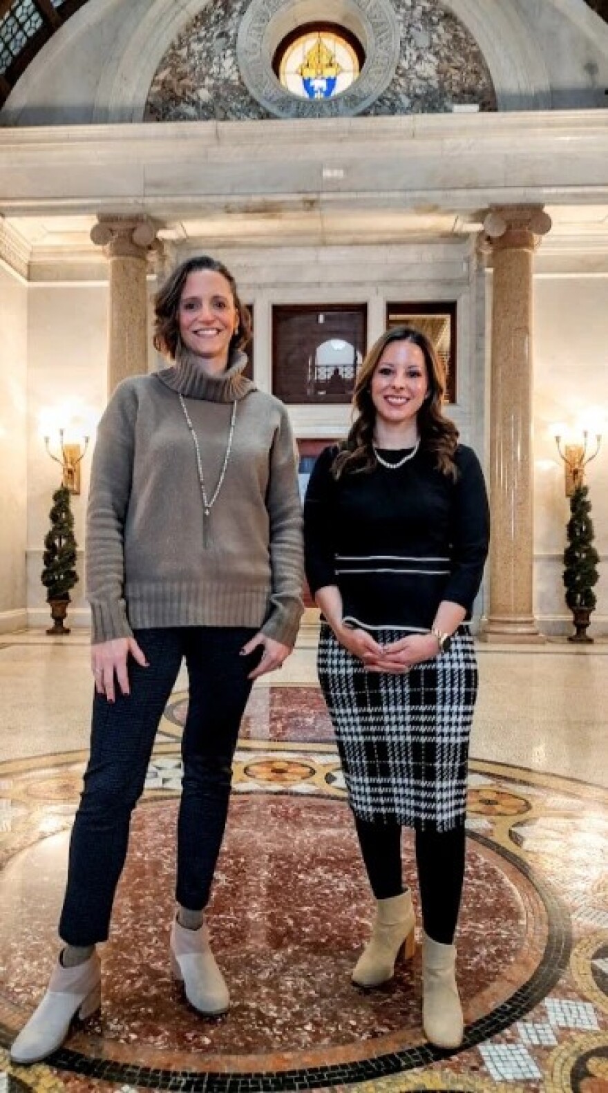 Ashlie Hand, left, of the Kansas City-St. Joseph Catholic Diocese, and Marissa Easter of the Archdiocese of Kansas City in Kansas have been working together to prepare local Catholics to welcome World Cup athletes and visitors in various ways. They are pictured in the lobby of the Catholic Center at 20 W. Ninth St. in Kansas City.