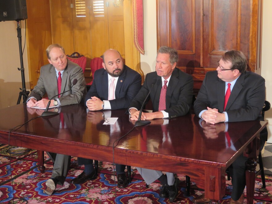Budget director Tim Keen, then-House Speaker Cliff Rosenberger, Gov. John Kasich and Senate President Larry Obhof discuss the state's budget shortfall in April 2017.