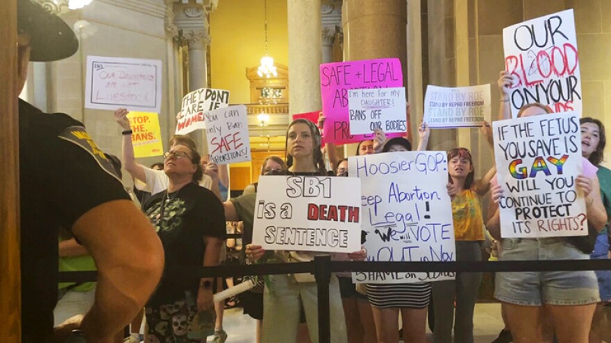 Abortion-rights protesters fill Indiana Statehouse corridors and cheer outside legislative chambers, Friday, Aug. 5, 2022, as lawmakers vote to concur on a near-total abortion ban, in Indianapolis.