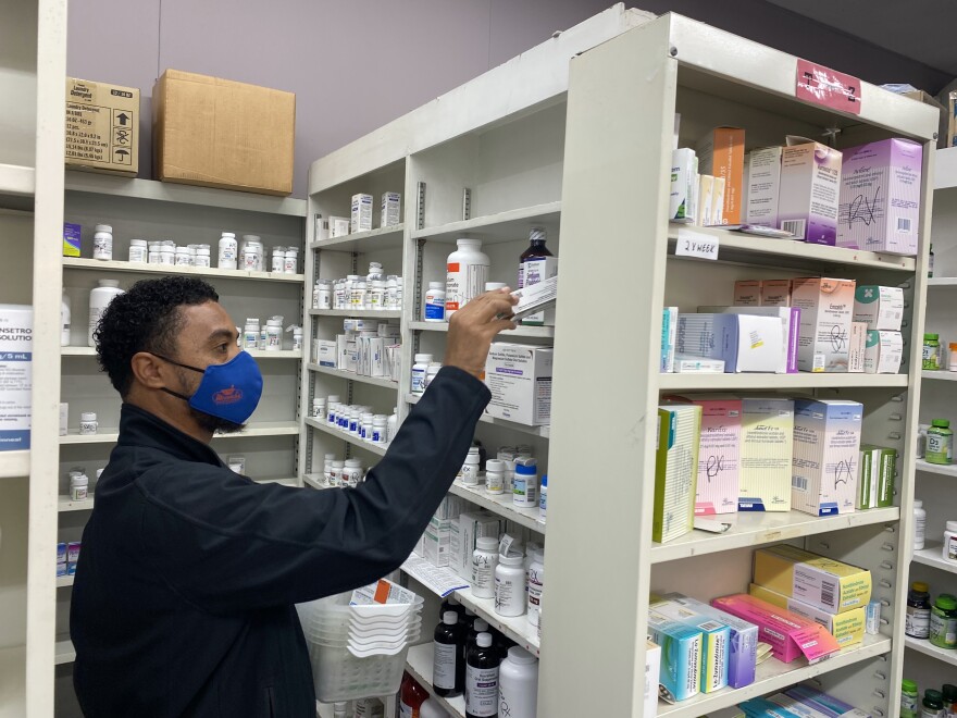Kaye'l Marrero, a pharmacy technician and front-end supervisor at Minnich's Pharmacy in York County, gathers medications.