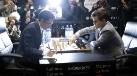 Fabiano Caruana, left, plays defending champion Magnus Carlsen in round 12 of the World Chess Championship match on Monday in London.