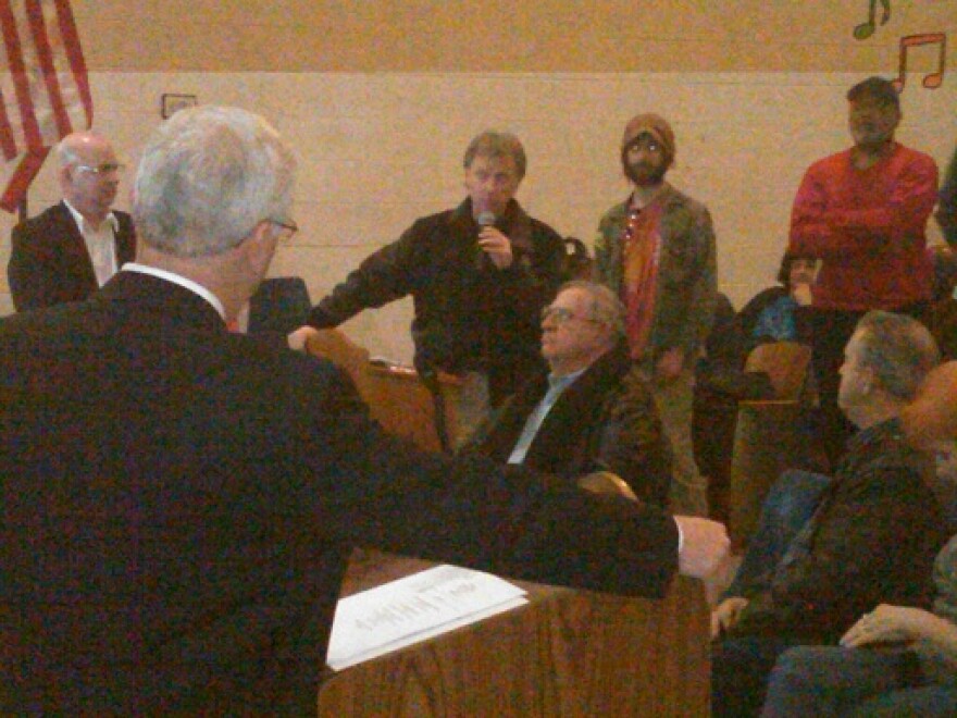 Flint emergency manager Michael Brown listens as he's asked about decisions he's made, or will soon make, during a community forum last night.