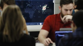 Kyle Martin, a worker at HealthMap, a system using artificial intelligence to monitor global disease outbreaks, mines health data to keep the system up to date in a work area at Boston Children's Hospital in Boston. 