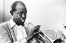 FILE - In a June 21, 1971 file photo, Louis Armstrong practices with his horn at his Corona, New York home. The Louis Armstrong House Museum announced Wednesday, April 20, 2016, that it has acquired the only known film footage of the great jazz musician in a recording studio. While many audio recordings of Armstrong's music exist there has been no video of him working in a recording studio until now. (AP Photo/Eddie Adams, File)