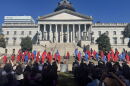 Red and blue silhouettes representing the 40 women and men who died from domestic violence are displayed during the 2026 Silent Witness Ceremony on the Statehouse grounds in Columbia.