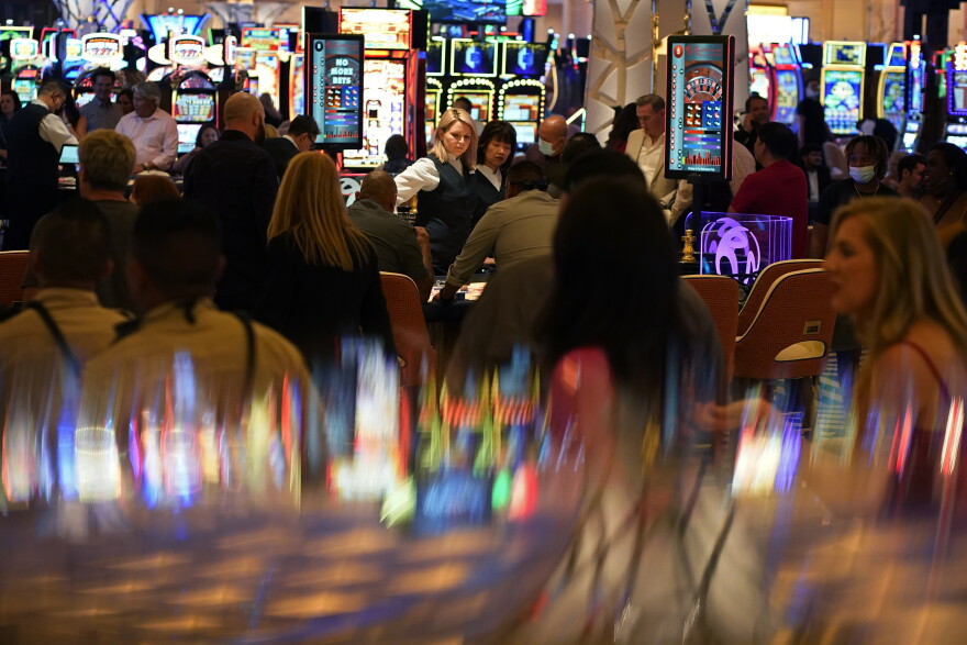 In this June 24, 2021 photo, visitors crowd the casino during the opening night of the Resorts World Las Vegas hotel-casino in Las Vegas.