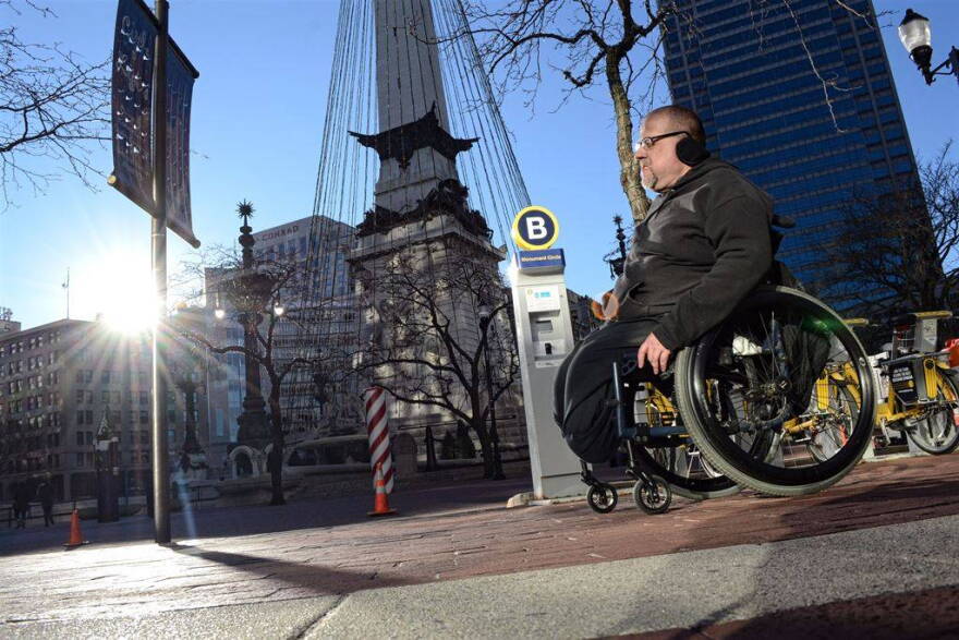 Richard Propes on lap 77 of 122 around Monument Circle on Saturday, Jan. 2, 2016 in his wheelchair to draw attention to the problem of violence against children.