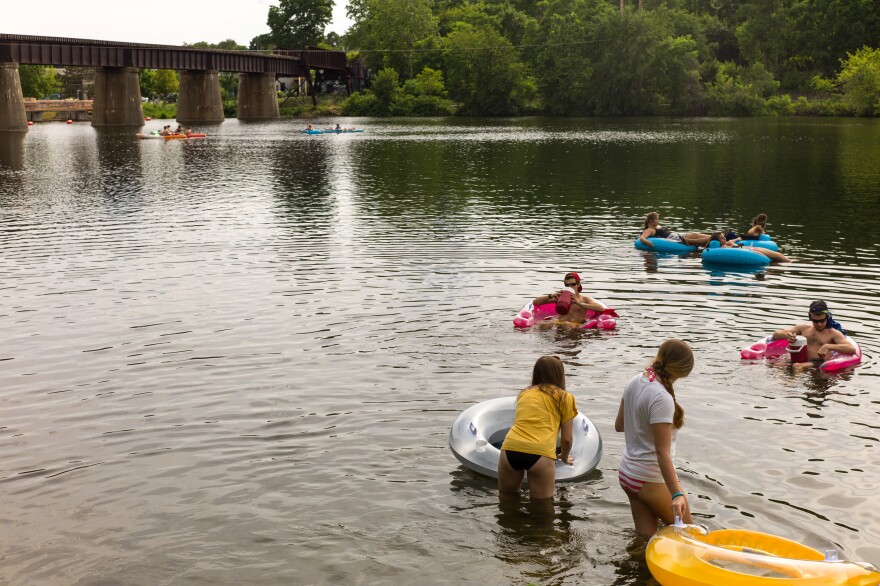 Swimmers and tubers go down the Huron River, a popular summer activity in Ann Arbor