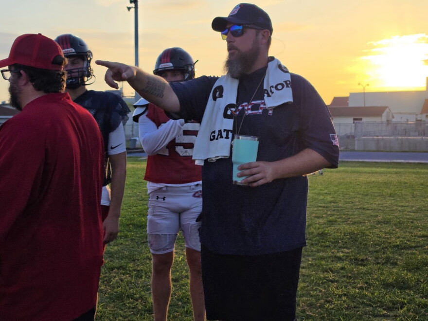 Ted Kimmey, Coach Beach High's athletic director and head football coach, during an early morning practice. Prior to having early morning practice twice a week, about 70% of the team's summer practices were either modified or cancelled due to dangerous heat.