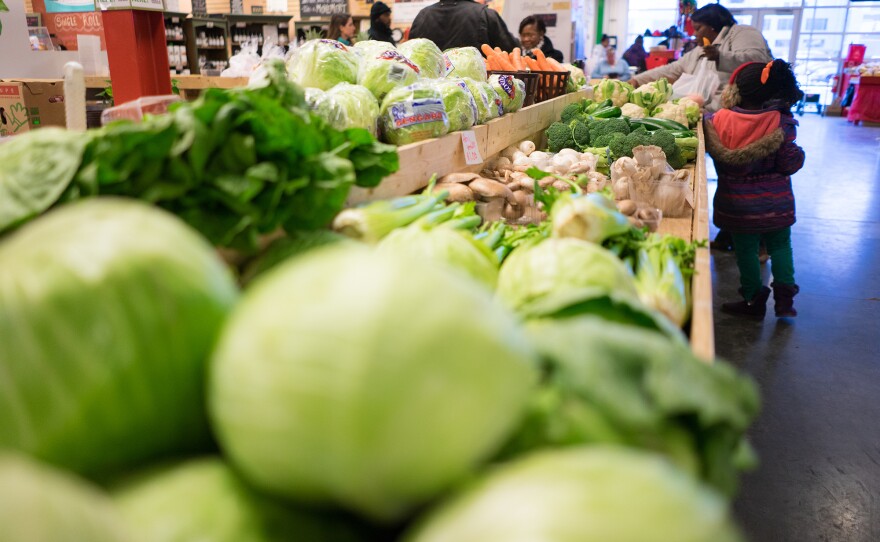 Customers shop for produce at the Flint Farmers' Market this week.