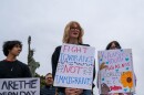 Darley Kasper, right, was one of dozens of protesters outside of city hall in Leavenworth, Kansas, who demonstrated against CoreCivic and the Trump administration's immigration policies.