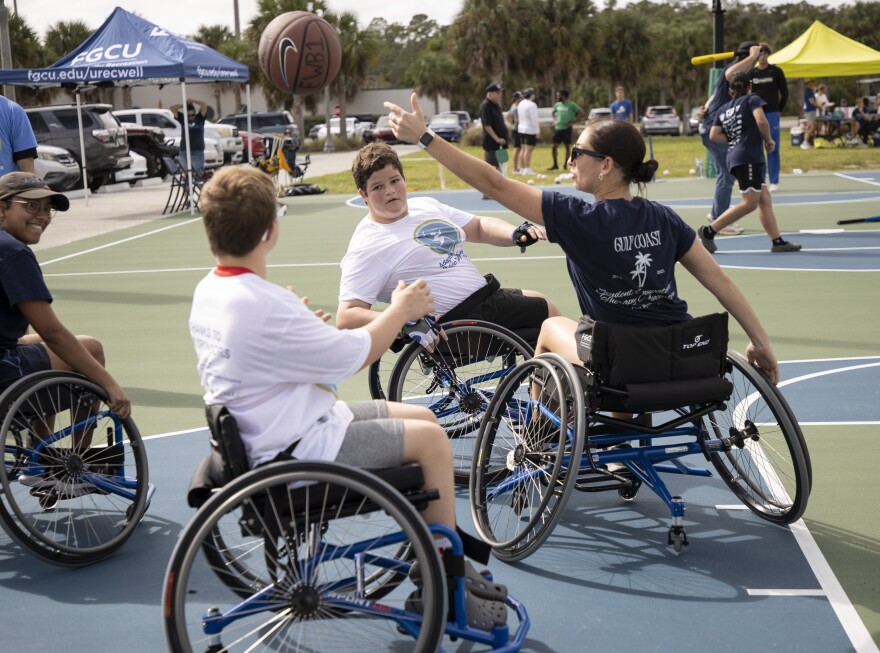 Justin Thomas, 10, center, plays basketball during Adaptive Sports Day at FGCU on Saturday, October 4, 2025.