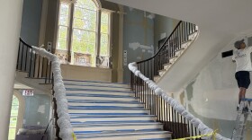 Crews work on painting the interior of the Boscobel main entry hall.