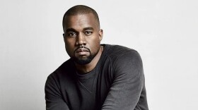 African American man in grey long-sleeve t-shirt stares into camera
