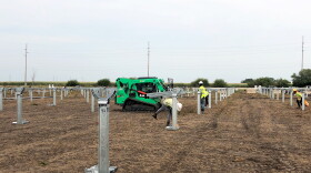 Workers prepare eight acres of a what would have been a corn field for a solar farm that is set to be operational by the end of 2019 in Kentland, IN.