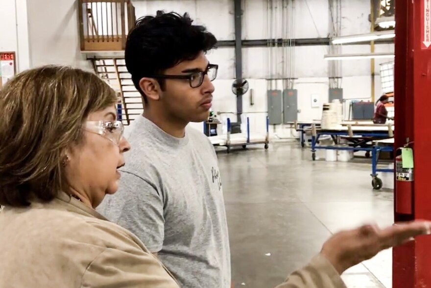 Chris Camacho, a youth apprentice in Elkhart County, learns about the operations of the factory on his first day.