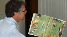 A teacher reads to elementary school students.