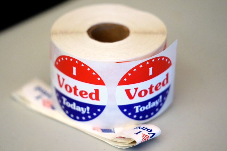 A spool of stickers rests on a table at a polling station during Massachusetts state primary voting, Sept. 3, 2024, at the Newton Free Library, in Newton, Mass.
