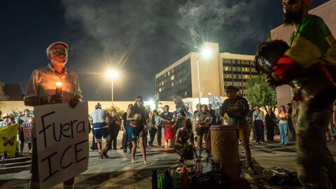 Dozens of people hold a vigil outside an immigration processing center in downtown Fresno, Calif. on Oct. 7, 2026.