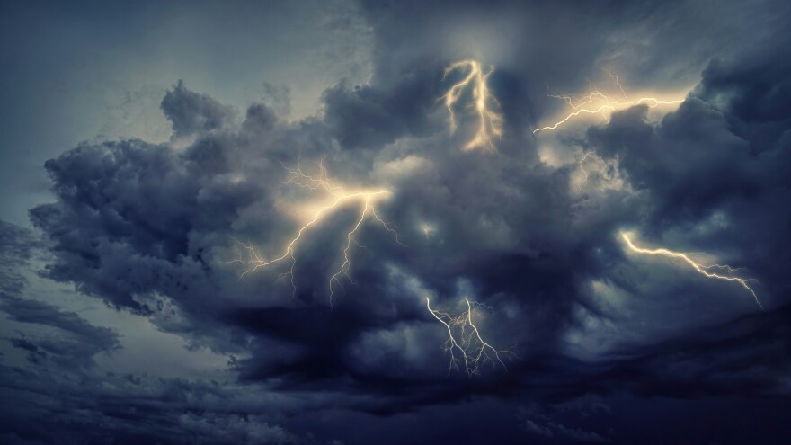 lightening flashes in a big storm cloud
