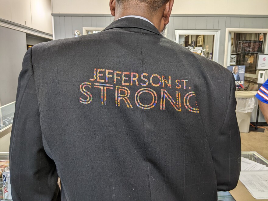 A back view of a suit with the inscription "JEFFERSON ST. STRONG" on it.