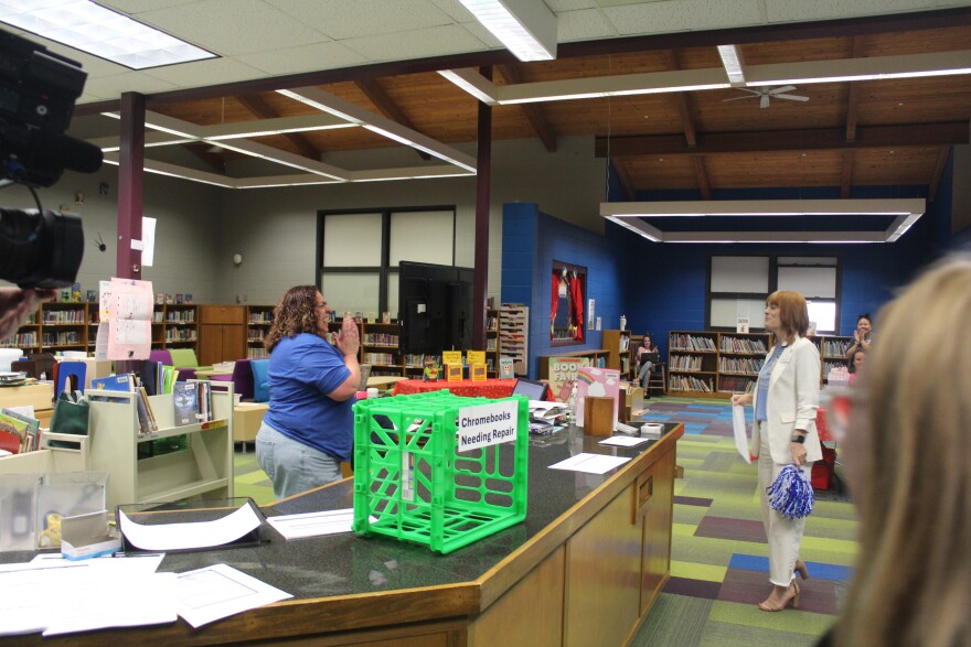 Truman Librarian Scarlett Braddock is greeted with a Back to School Grant by the Springfield Public Schools Foundation.