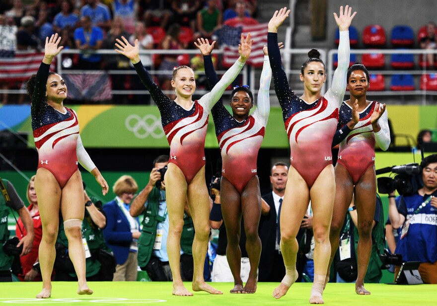 (Left to right) Laurie Hernandez, Madison Kocian, Simone Biles, Aly Raisman and Gabby Douglas celebrate after winning the winning the gold medal in women's gymnastics on Tuesday.