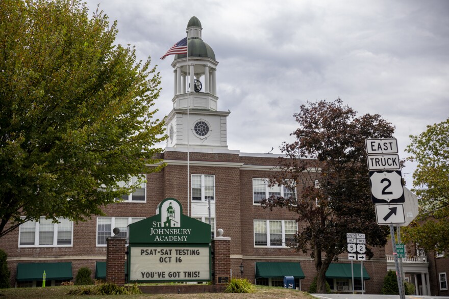 A school building with a sign notifying the community about PSAT and SAT testing dates