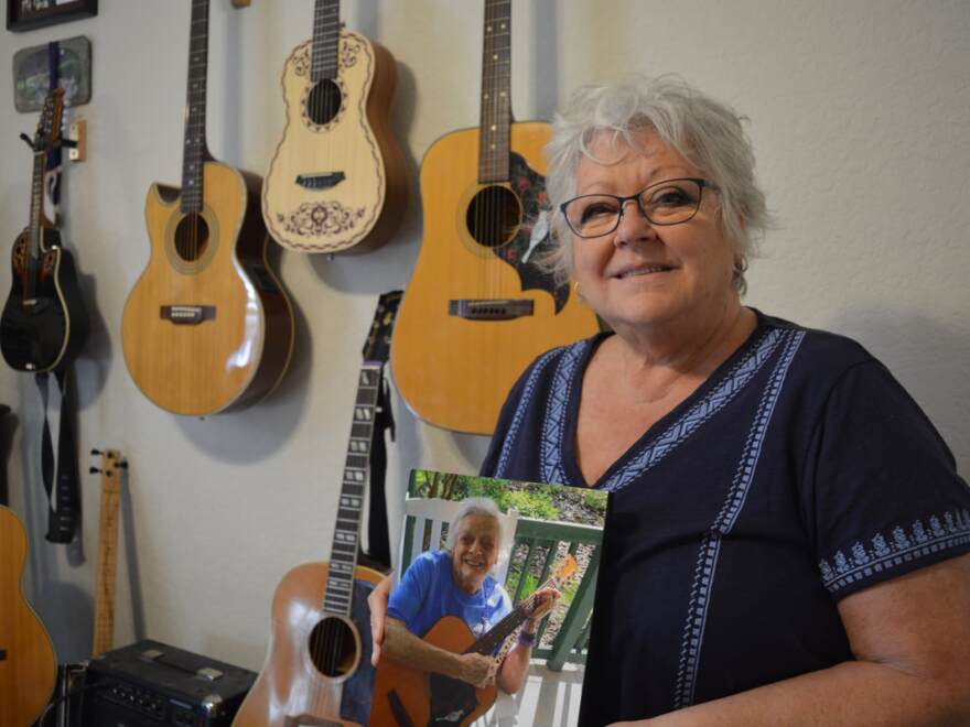 Roxanne Laurendeau holds a photo of her mother, Betty Marr, who died of vascular dementia on Oct. 13, 2016. Marr taught her daughter to play the guitar when she was around 13 years old when she bought her a music book filled with songs from The Beatles. (Christina Morales/WUFT News)