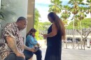 Chico Kaonohi, left, prays with Priscilla Hoʻopiʻi, center, and Lana Vierra, right, outside U.S. District Court in Honolulu, Thursday, Nov. 17, 2022, after his Native Hawaiian son was found guilty of a hate crime in the 2014 beating of a white man. U.S. District Judge J. Michael Seabright ordered Kaulana Alo-Kaonohi and Levi Aki Jr. detained pending sentencing scheduled for March 2, 2023. (AP Photo/Jennifer Sinco Kelleher)