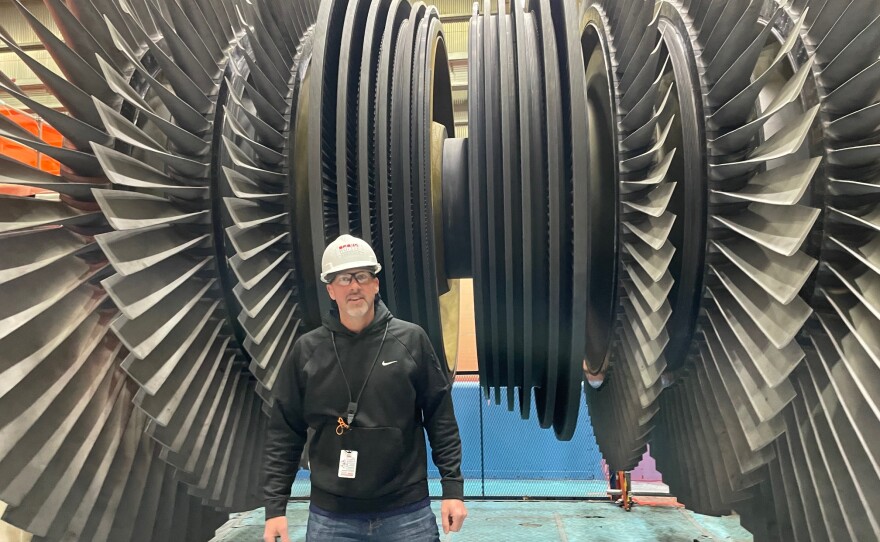 Steve Shipe, a project manager at Palisades, stands in front of the massive turbine blades, which have been taken out of the turbine for inspections as Shipe oversees the work to restart the nuclear plant.