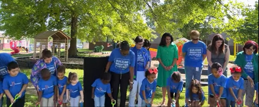 Kids gather with Lexington officials for the ground breaking of a new outdoor play and education area at the Lexington Family Care Center