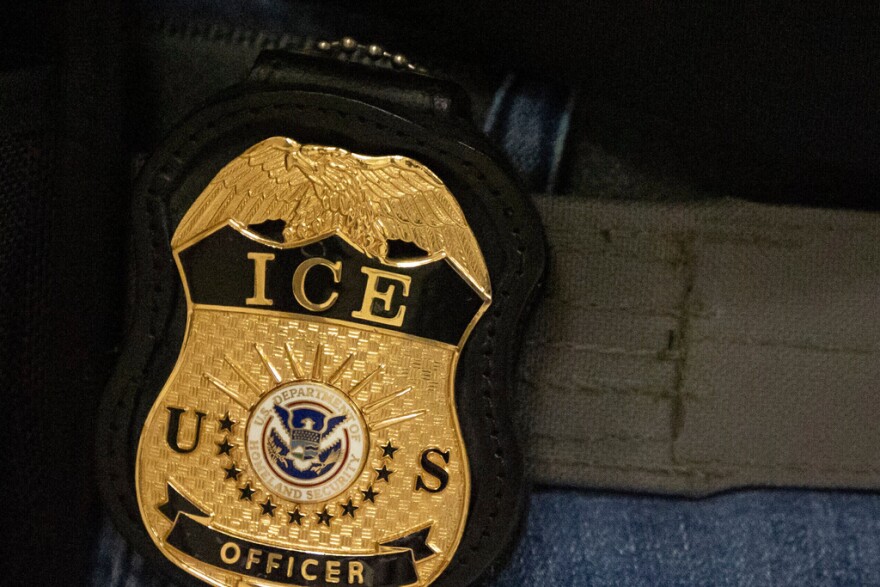 A federal agent wears an Immigration and Customs Enforcement badge in this June 10, 2025, file photo.