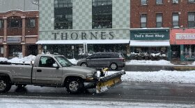 A truck with a plow drives through downtown Northampton, Mass., on the morning of Feb. 28, 2023.