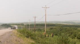 firefighters outside near a dirt road