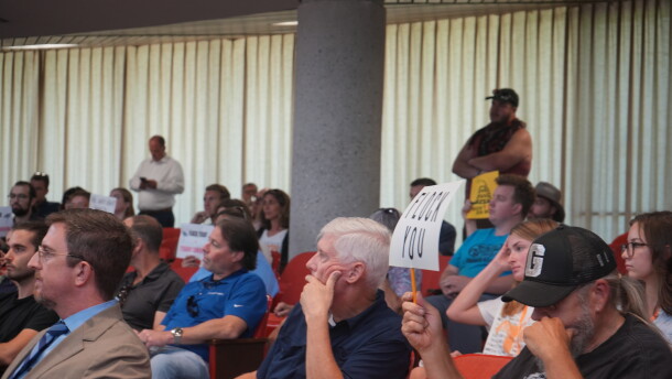 Knox County residents hold up signs opposing automatic license plate readers during a public workshop on August 24, 2026.