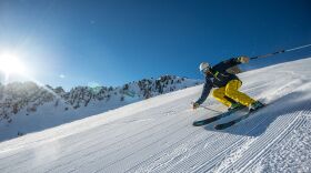 A person skiing down a snowy mountain