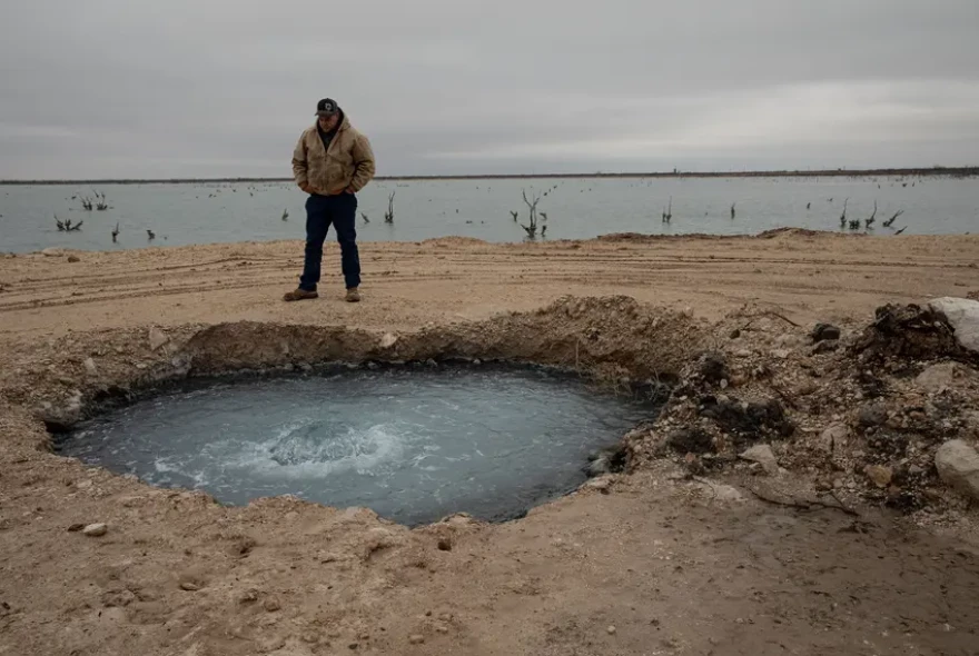 Hawk Dunlap stands at the site of Lake Boehmer, a brine lake that has leaked out of an old well in Pecos County. The Texas Commission on Environmental Quality received $10 million from lawmakers in 2023 to plug such wells but has yet to spend any of the money as it completes the rule making process.