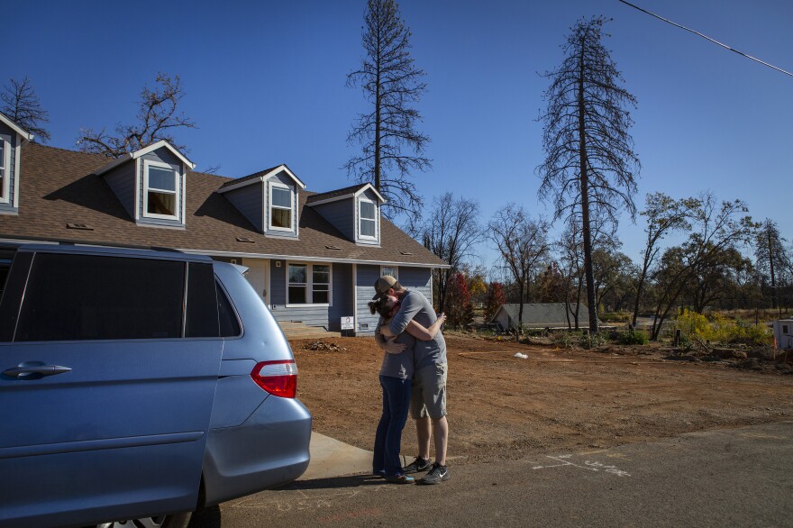 Noah and Chelsea hug after taking the kids to look at their new house that's being rebuilt in Paradise. The family members say they are thankful for their time in the trailer; it gave them a place to call home in a time of extreme transition.