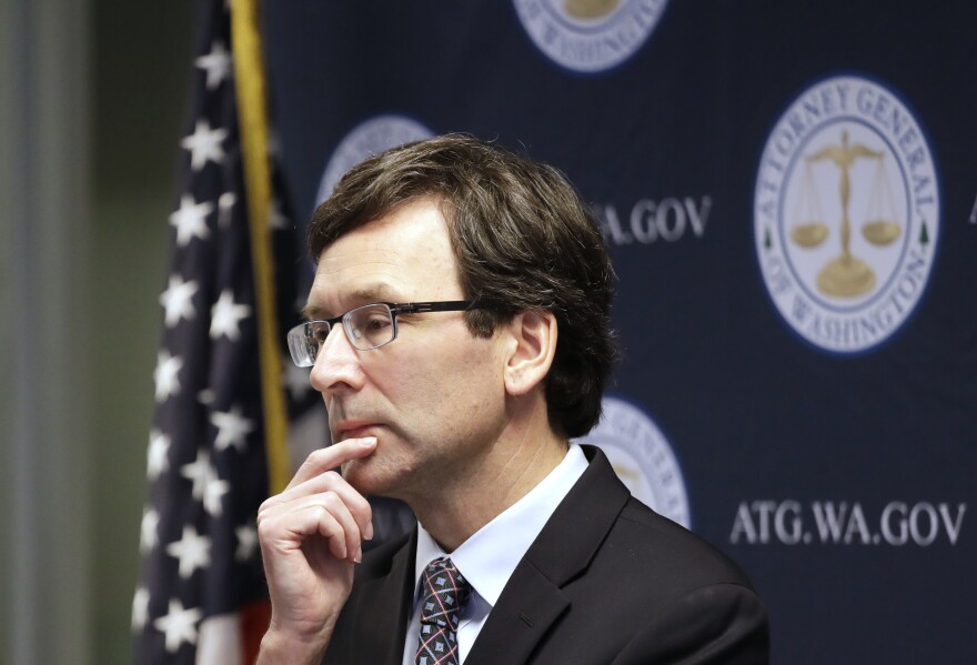 Washington state Attorney General Bob Ferguson looks on during a news conference in Seattle on Dec. 17, 2019. Ferguson rejected a half-billion-dollar settlement offer, and now he's taking the state's case against the nation's three biggest drug distributors to trial Monday, Nov. 15, 2021. He says they must be held accountable for their role in the opioid crisis.