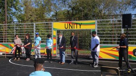 Mayor Joe Hogsett cuts the ribbon alongside Ray Gaddis and students from KIPP Indy College Prep Middle School. The celebration was for the grand opening of a new mini-pitch at Oscar Charleston Park.