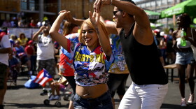 Shakria Soto dances with Luis Quiris after the CICD Puerto Rican Parade, "El Chinchorreo Caravan & Music," a thank-you to health care and essential workers. The caravan ended with a celebration and vaccine clinic at Parkville Market in Hartford, Connecticut, on June 5, 2021.