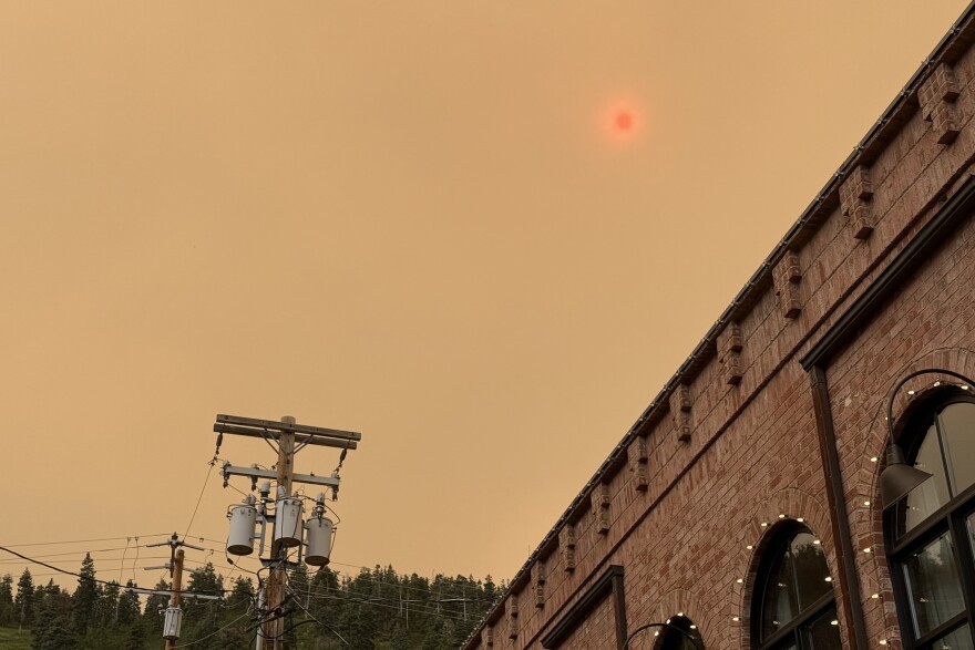 A red sun hangs in the smoke over Park City, Utah, as ash falls from the sky, drifting in from fires elsewhere in the state June 26, 2026.