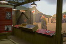 A wall mural of military nurses helping injured soldiers at a real evacuation hospital from WWII can be seen behind displays of Iowa nurses' stories and artifacts.