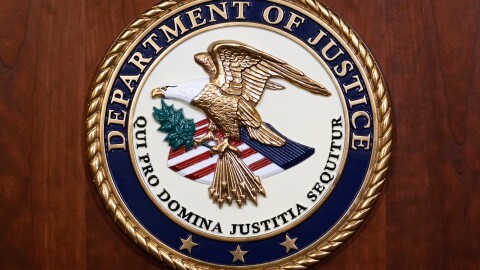 The seal of the Dept of Justice is shown on the podium, Aug. 1, 2023, at an office of the Department of Justice in Washington.