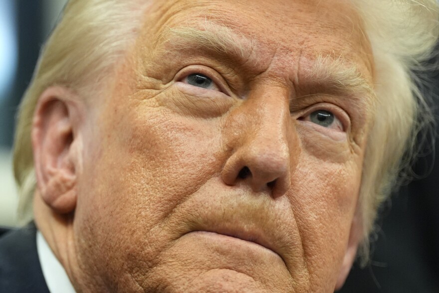 President Donald Trump listens to a question from a reporter as he signs executive orders in the Oval Office at the White House, Monday, Feb. 10, 2025, in Washington.