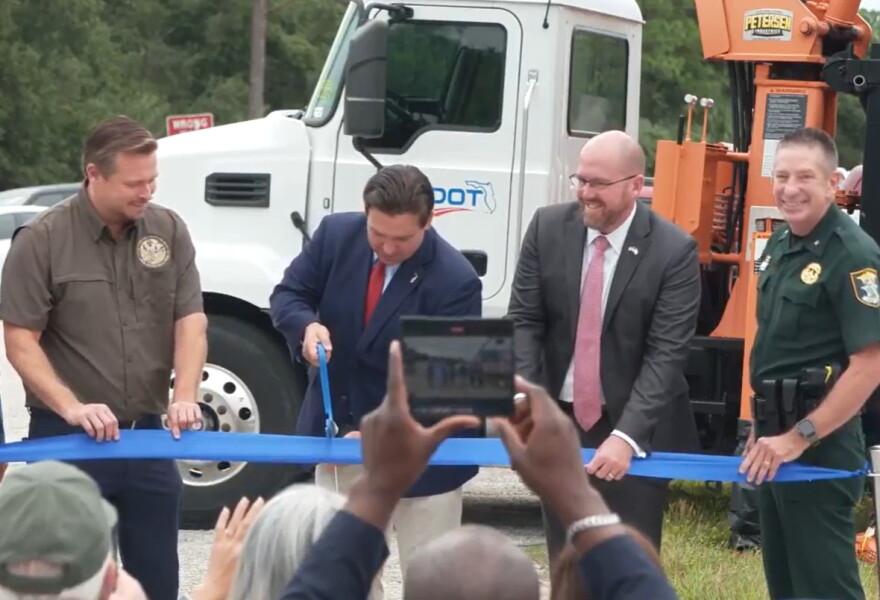 Florida Governor Ron DeSantis cuts the ribbon to denote completion of the State Road 777 (Rover Road) widening project in Sarasota County, Friday.
