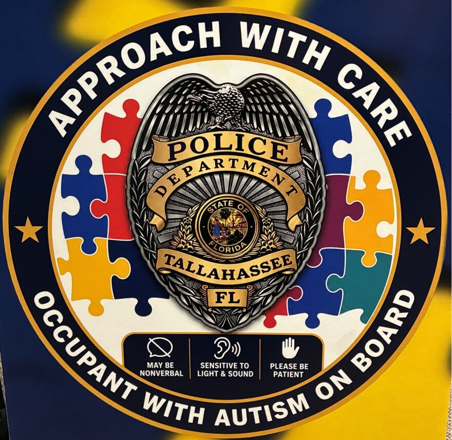 This TPD decal has a badge and the words "Approach with care. Occupant with autism on board."