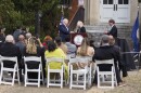 Gov. Abigail Spanberger hands developer Edwin Gaskin the keys to two buildings at Fort Monroe. Gaskin will turn those vacant buildings into housing.
