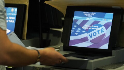 A Miami-Dade County Elections Department employee tests voting equipment that will be used in the upcoming state primary election, Wednesday, Aug. 3, 2022, in Doral, Fla. Early voting starts Monday, Aug. 8. (AP Photo/Marta Lavandier)